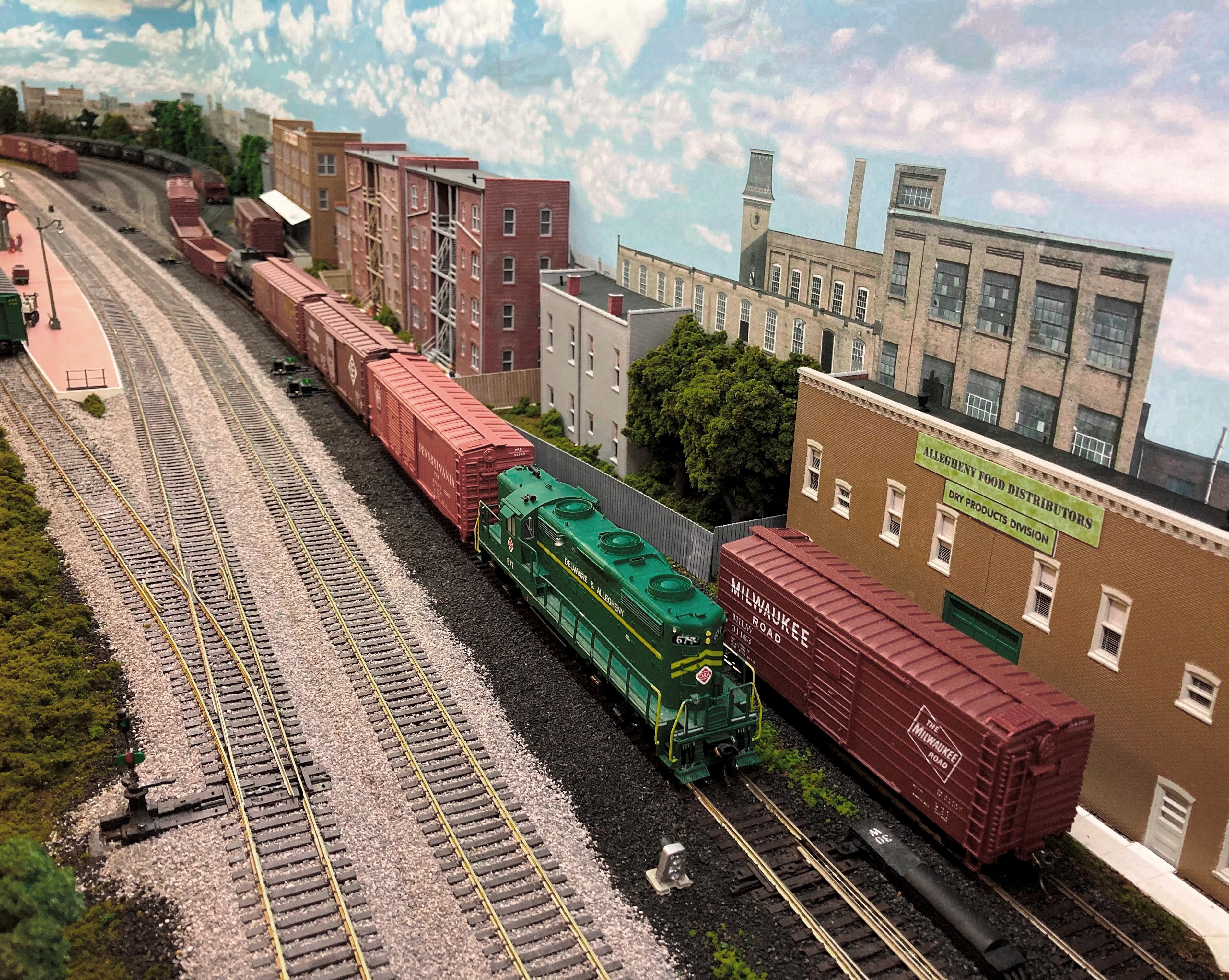 Photo 1 - EMD GP18 No. 677 waits for the signal to depart Bigler Avenue Yard at Clearfield, PA at Slope Interlocking with the outbound Wallaceton Local.